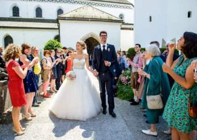 Brautpaar bei ihrer Trauung, umgeben von Gaesten und Seifenblasen auf der Fraueninsel.