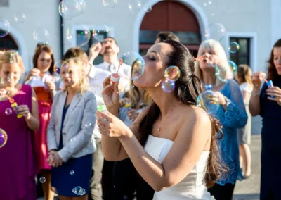 Braut und Gaeste bei Hochzeit im Schloss Seefeld, Seifenblasen und Freude. Hochzeitsreportage westlich von Muenchen.