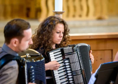 Musiker bei einer Hochzeit in Sendling, spielen Akkordeon. Hochzeitsfotograf Reportage aus Muenchen, Oberbayern.