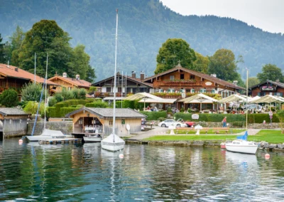 Seehotel Malerwinkel am Tegernsee, Boote und Huetten am Ufer, ideal als Kulisse fuer Hochzeitsfotografie.