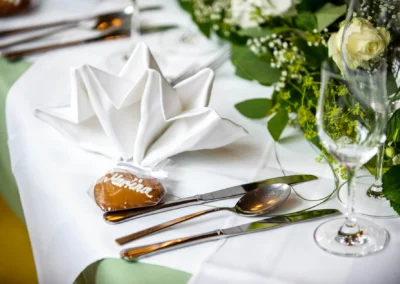 Gedeckter Hochzeitstisch mit Besteck und Lebkuchenherz bei einer Hochzeitsreportage in Pullach.