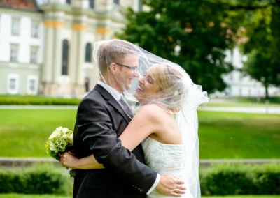 Brautpaar lacht beim Hochzeitsfotografen-Shooting im Freien in Kloster Fuerstenfeld nahe Muenchen. Hochzeitsportraits.