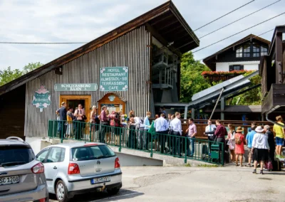 Hochzeitsgesellschaft wartet an der Schliersberg-Bahn bei einer Hochzeitsreportage in Oberbayern.