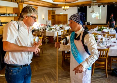 Hochzeitsreportage im Gasthof Widmann: Zwei Personen im Gespraech bei einer Hochzeit in OBB.