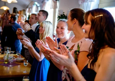 Gäste applaudieren bei einer Hochzeit in Oberbayern, eingefangen in einer Hochzeitsreportage nahe München.