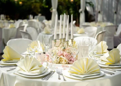 Festlich gedeckter Tisch mit Kerzenleuchter und Blumenarrangement bei Hochzeit in der Alten Gaertnerei Taufkirchen.