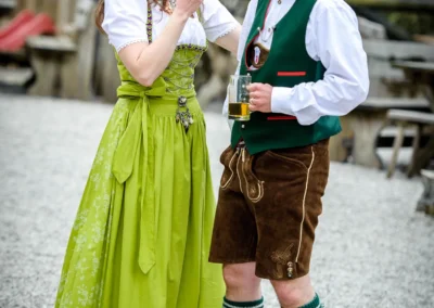 Lachendes Brautpaar im traditionellen Tracht bei einer Hochzeit im Bio Landhotel Moarwirt, Hechenberg.