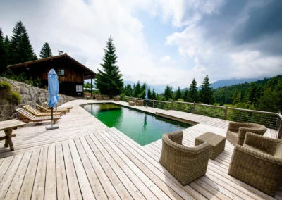 Holzterrasse mit Pool und Berghütte im Almbad-Sillberghaus, ideal für eine Berg-Hochzeitsreportage in Oberbayern.