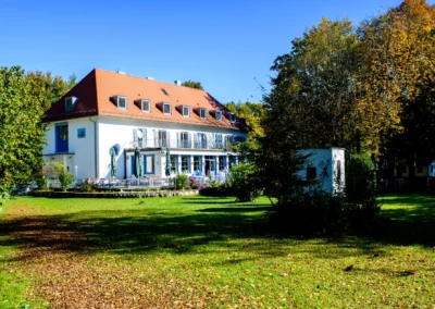 Hochzeitslocation im Waldhaus Alte Tram bei Muenchen, umgeben von Baeumen, ideal fuer Hochzeitsfotografie.
