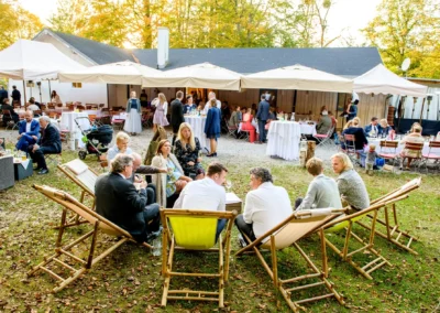 Gäste entspannen in Liegestühlen bei einer Hochzeit im Grünen. Hochzeitsreportage im Gruenwalder Forst.