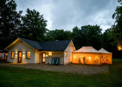 Hochzeitslocation mit beleuchtetem Zelt im Gruenwalder Forst bei Nacht, Teil der Hochzeitsreportage.