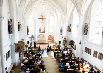 Kirchliche Trauung in Aufkirchen, Brautpaar am Altar, Hochzeitsfotografie Hochzeitsreportage Oberbayern.