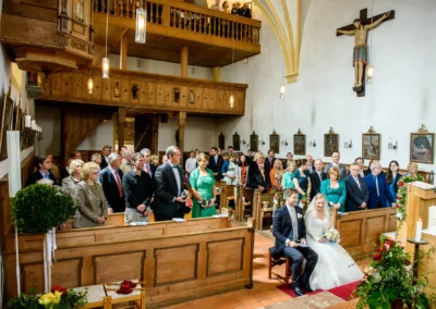 Kirchliche Trauung in Schaftlach: Brautpaar und Gaeste in Kirche, Hochzeit Hochzeitsreportage, stilvolle Zeremonie.
