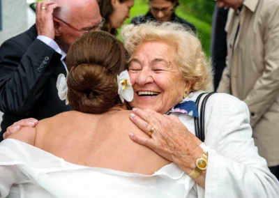 Braut umarmt lachende Frau bei Hochzeit auf Gut Thurnsberg nördlich von Muenchen, Hochzeitsfotografie in Oberbayern.