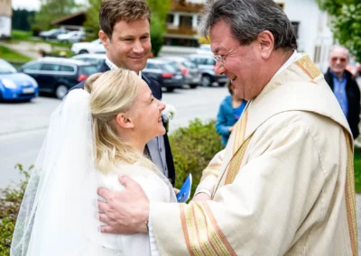 Braut lacht bei kirchlicher Trauung in Schaftlach, Hochzeitsreportage zeigt emotionale Momente.