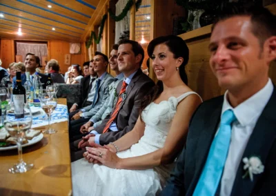 Gäste lachen bei einer Hochzeitsfeier in Arget, festgehalten von einem Hochzeitsfotografen aus München.