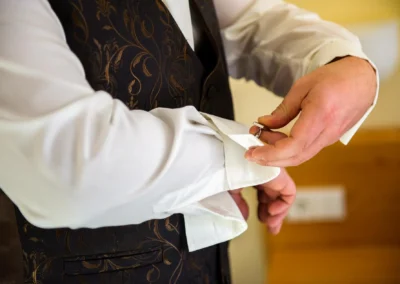 Mann befestigt Manschettenknopf waehrend Hochzeitsvorbereitung nahe Dillingen, Hochzeitsfotografie.