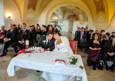 Brautpaar bei standesamtlicher Trauung im Schloss Hoechstaedt an der Donau, Gaeste sitzen im Hintergrund.