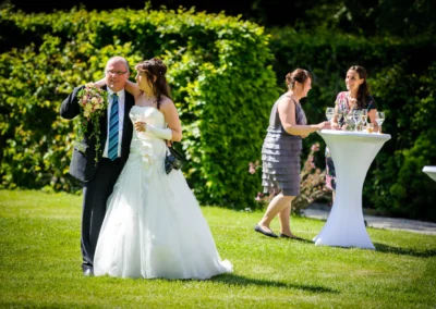 Braut in weissem Kleid bei einer Hochzeitsfeier im Garten von Schloss Aufhausen nahe Muenchen.