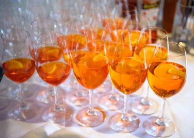 Gläser mit Orangenscheiben und orangefarbenem Getränk für Hochzeitsfeier in Schloss Blutenburg bei Hochzeitsreportage.